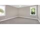A bedroom featuring carpet, neutral paint, and two windows at 67 Farmstead Ct, Wendell, NC 27591