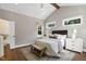 Bright bedroom featuring a vaulted ceiling, hardwood floors, and large windows at 67 Farmstead Ct, Wendell, NC 27591
