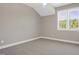 This bedroom features neutral walls, carpet, a large window looking out to the trees at 67 Farmstead Ct, Wendell, NC 27591
