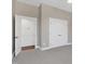 This bedroom features neutral walls, carpet, an open door to the closet, and closet doors at 67 Farmstead Ct, Wendell, NC 27591