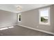 Neutral bedroom with large windows and carpeted floors at 67 Farmstead Ct, Wendell, NC 27591