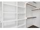 Bright walk-in closet with a custom shelving system and hardwood floor at 67 Farmstead Ct, Wendell, NC 27591