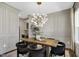Elegant dining room with wainscoting, modern chandelier, and stylish decor at 67 Farmstead Ct, Wendell, NC 27591
