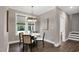 Charming dining room with modern chandelier and natural light from the large windows at 67 Farmstead Ct, Wendell, NC 27591