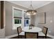 Charming dining room with modern chandelier and natural light from the large windows at 67 Farmstead Ct, Wendell, NC 27591