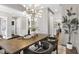 Elegant dining room with hardwood floors, modern chandelier, and wainscoting detail at 67 Farmstead Ct, Wendell, NC 27591