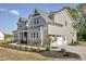 Beautiful two-story house with gray siding, stone accents, and well-maintained landscaping at 67 Farmstead Ct, Wendell, NC 27591