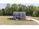 A charming two-story home features a gray exterior and professional landscaping at 67 Farmstead Ct, Wendell, NC 27591