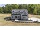 Two-story home featuring a gray exterior, black roof, and manicured landscaping at 67 Farmstead Ct, Wendell, NC 27591