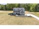 Two-story home with gray exterior, a front porch and manicured landscaping at 67 Farmstead Ct, Wendell, NC 27591