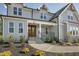 Inviting front entrance with a double wooden door, stone steps, metal railing and manicured landscaping at 67 Farmstead Ct, Wendell, NC 27591