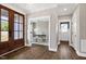 Hallway view towards home office; entry door in foreground. Dark hardwood floors throughout at 67 Farmstead Ct, Wendell, NC 27591