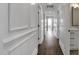 Hallway with white trim and doors, wood floor, and natural light at 67 Farmstead Ct, Wendell, NC 27591