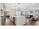 Spacious kitchen with a large island, modern lighting, and seamless flow into the living room at 67 Farmstead Ct, Wendell, NC 27591