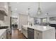 Open-concept kitchen features an island with a white countertop, sink, and stainless steel dishwasher at 67 Farmstead Ct, Wendell, NC 27591