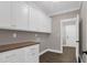 Functional laundry room with custom cabinets and hardwood floor at 67 Farmstead Ct, Wendell, NC 27591
