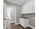 Laundry room with custom cabinets and door to bedroom at 67 Farmstead Ct, Wendell, NC 27591