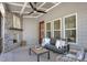 Inviting porch featuring a stone fireplace, comfortable seating, and a ceiling fan at 67 Farmstead Ct, Wendell, NC 27591