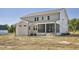 The rear exterior of a gray two-story home featuring a screened porch at 67 Farmstead Ct, Wendell, NC 27591