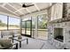 Relaxing screened porch with stone fireplace, comfortable seating, and outdoor views at 67 Farmstead Ct, Wendell, NC 27591