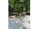Outdoor deck area surrounded by lush greenery, offering a serene space for relaxation and enjoying nature at 6765 Rock Service Station Rd Rd, Raleigh, NC 27603