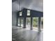 Bright living room featuring vaulted ceilings, large windows with wooded views, and elegant tile flooring at 6765 Rock Service Station Rd Rd, Raleigh, NC 27603