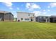 The large backyard with newly installed sod connects to an outdoor living space at 708 Deschutes Dr, Garner, NC 27529