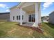 A covered patio area with sliding glass doors overlooks the grassy backyard of this home at 708 Deschutes Dr, Garner, NC 27529