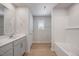 A well-lit bathroom featuring double sinks, a bathtub, a window, and modern fixtures at 708 Deschutes Dr, Garner, NC 27529