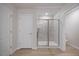 Modern bathroom featuring a walk-in shower with glass doors, tiled walls, and neutral flooring at 708 Deschutes Dr, Garner, NC 27529