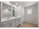 A well-lit bathroom featuring double sinks, a window, and modern fixtures at 708 Deschutes Dr, Garner, NC 27529
