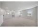 Light-filled bonus room featuring neutral paint, plush carpet and large windows at 708 Deschutes Dr, Garner, NC 27529