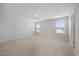 Bright bonus room offering a large area with plush carpet, neutral walls, and abundant natural light at 708 Deschutes Dr, Garner, NC 27529