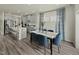 Open-concept dining area with seating for six, hardwood floors, and a modern design at 708 Deschutes Dr, Garner, NC 27529