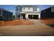 Two-story home exterior with blue and gray siding and a two-car garage in a construction phase at 708 Deschutes Dr, Garner, NC 27529