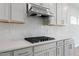 Close-up of kitchen featuring stainless steel appliances, gray cabinets, and white quartz countertops at 708 Deschutes Dr, Garner, NC 27529