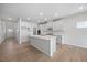 Modern kitchen with gray cabinets, a central island, stainless steel appliances, and hardwood floors at 708 Deschutes Dr, Garner, NC 27529