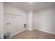 A compact laundry room with laminate flooring, hookups, and a wire shelf at 708 Deschutes Dr, Garner, NC 27529