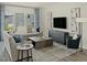 Cozy living room with a comfortable sofa, modern decor, large windows, and stylish furnishings at 708 Deschutes Dr, Garner, NC 27529