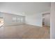 Spacious living room with hardwood floors, large windows, and doorway to bathroom at 708 Deschutes Dr, Garner, NC 27529