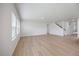 Open-concept living room with hardwood floors and staircase at 708 Deschutes Dr, Garner, NC 27529