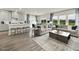 Spacious living room with hardwood floors, a kitchen island, comfortable seating, and natural light at 708 Deschutes Dr, Garner, NC 27529