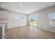 Bright, open-concept living room with hardwood floors and sliding glass doors at 708 Deschutes Dr, Garner, NC 27529