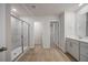 Modern main bathroom featuring a glass shower, wood-look floor, and a double vanity at 708 Deschutes Dr, Garner, NC 27529