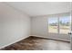 Well-lit bedroom with hardwood floors and outside view at 7289 Nc 561, Louisburg, NC 27549