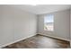 Bedroom featuring hardwood floors and large window at 7289 Nc 561, Louisburg, NC 27549