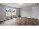 A spacious bedroom with modern wood-look flooring and ample natural light at 7289 Nc 561, Louisburg, NC 27549