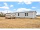 Charming home with gray siding, complemented by a wooden deck, and ample yard space at 7289 Nc 561, Louisburg, NC 27549