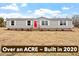 Charming single-story home featuring a bright red front door and situated on a spacious lot at 7289 Nc 561, Louisburg, NC 27549