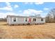 Inviting home featuring gray siding, white-framed windows, and a vibrant red front door at 7289 Nc 561, Louisburg, NC 27549